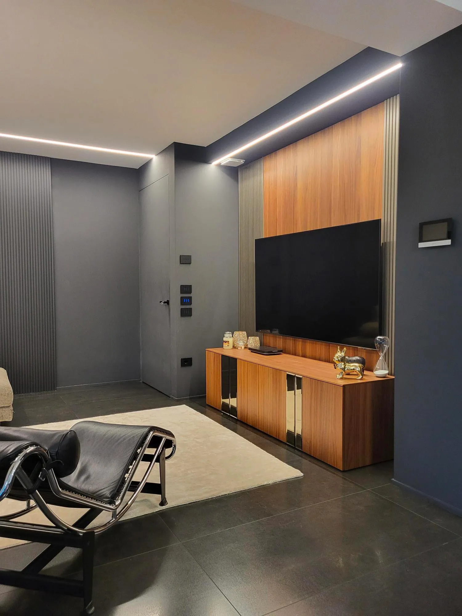 Living area featuring bold design with black lacquer and faded gold surfaces.